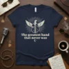 The Greatest Band That Never Was text with a winged guitar graphic on a navy blue t-shirt