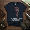 T-shirt with the quote "The Journey of a Thousand Steps Begins With A Single Footprint" and a stylized footprint graphic