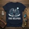 The Kelpies t-shirt design featuring two stylized dark horses emerging from water under a pale moon