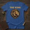 The King text above a circular graphic of a lion's head with a crown below on a blue t-shirt