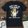 The Lab Is Calling And I Meowst Go quote with a cat scientist graphic on a dark t-shirt
