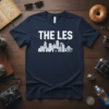THE LES text above a white city skyline graphic with bridge on a navy blue t-shirt