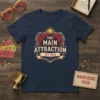 The Main Attraction Est. 2024 text design with vintage circus frame and red curtains, navy t-shirt