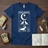 The Moon XVIII tarot card design with two wolves howling at the moon, on a navy blue t-shirt