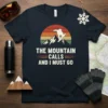 T-shirt with "The Mountain Calls And I Must Go" text, a snowboarder silhouette, and a retro mountain sunset graphic