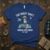 The Night Shift Urban Explorer Est. 2023 T-Shirt featuring a raccoon with a flashlight on books under a moonlit sky