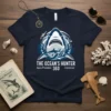 The Ocean's Hunter Apex Predator 360 Untamed text with great white shark graphic on a navy blue t-shirt