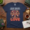T-shirt with "The Only Thing More Powerful Than Hate Is Love" text and a tree design made of diverse hands