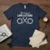 Navy blue t-shirt with white text "The Original LOVE LETTERS" above symbols of nails and crown of thorns