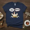 Navy t-shirt with a cartoon hen in a nest saying "The Poor Girl Girl Is Out Of Eggs" and "Henopause"