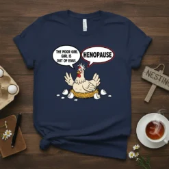 Navy t-shirt with a cartoon hen in a nest saying "The Poor Girl Girl Is Out Of Eggs" and "Henopause"