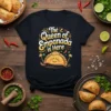 Black t-shirt with "The Queen of Empanada is Here" text and a cute empanada graphic wearing a crown