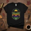 The Raven October 26 T-Shirt design featuring two ravens on a crest with a sunset and forest background