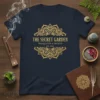 Navy blue t-shirt featuring "The Secret Garden Tranquility & Growth Est. 2024" in a golden mandala design
