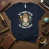 The Smart Friend The Smart Friend text on a t-shirt with a cartoon owl wearing glasses and a brain, holding