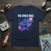 The Space Boss T-Shirt featuring a blue robot piloting a rocket through a colorful galaxy with stars and planets