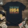 Retro t-shirt design with text 'The Star 1954 Was Born' in vintage colors and bursting star graphic