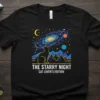 The Starry Night Cat Lover's Edition t-shirt design featuring a cat looking at a galaxy and mountains