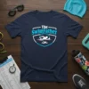 The SwimFather t-shirt design featuring text and silhouette of swimmers in water, navy blue shirt