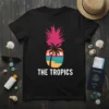 Black t-shirt with "THE TROPICS" text and a pineapple graphic featuring a tropical sunset beach scene