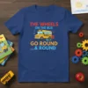 The Wheels On The Bus Go Round text with a cartoon school bus graphic on a blue t-shirt