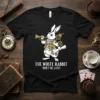Black t-shirt featuring The White Rabbit Don't Be Late quote with a steampunk-inspired white rabbit graphic, playing a trumpet