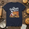 The Woman Behind THE PIES text and graphic on a navy blue t-shirt, featuring a baker with pies and a