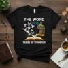 Black t-shirt with white text "THE WORD leads to freedom", an open book, flying doves, and a birdcage graphic
