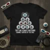 T-shirt design with text "They Are Always Watching Channel Surfers of the Soul" above a pyramid of eyeballs and a
