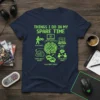 T-shirt graphic listing "Things I Do In My Spare Time" with icons for playing games, watching gameplay, researching games, dreaming