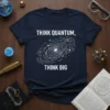 Navy t-shirt with white text "Think Quantum, Think Big" and a stylized galaxy graphic in the center