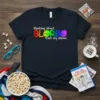 Navy t-shirt with "thinking about BLORBO from my shows" in rainbow gradient text and cute character faces
