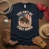 This Ain't My First Rodeo text with horse and American flag graphic on a navy blue t-shirt