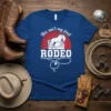 This ain't my first RODEO t-shirt with a white horse and lasso graphic on a blue background