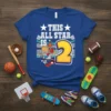 Blue t-shirt with "THIS ALL STAR IS 2" text and various sports icons, celebrating a second birthday