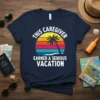 This Caregiver Earned A Serious Vacation quote on a navy t-shirt with a retro sunset and palm tree graphic