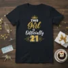 This Girl is Officially 21 text with crown graphic on a black t-shirt, gold and white design