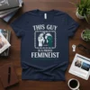 Navy t-shirt with white text "THIS GUY IS A PROUD FEMINIST" and graphics of fists and the earth, feminist design