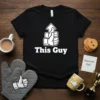 Black t-shirt with white text "This Guy" and a graphic of a hand giving a thumbs up with an upward