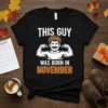 This Guy Was Born In November text with a muscular man graphic on a black t-shirt, ideal for November birthdays