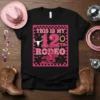 This Is My 12th Rodeo graphic tee featuring pink text, a bull skull, and a horse rider