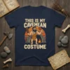 This Is My Cavemean Costume t-shirt featuring a cartoon caveman holding a club and a drumstick, with a sunset and