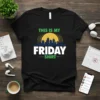 Black t-shirt with "THIS IS MY FRIDAY SHIRT" text in green and white, featuring a city skyline graphic and a