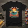 Retro sunset graphic with palm trees, surfboards, and waves that reads "This Is My Hawaiian Shirt"