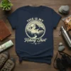 This Is My Hiking Shirt design with mountains, trees, and a winding path, printed on a navy t-shirt