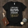 Black t-shirt with white and gold text: "This Is My Human Costume My Real Body Is In Heaven" quote and