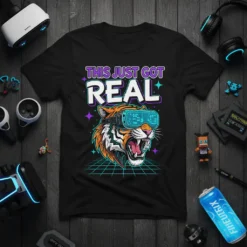 Black t-shirt with "THIS JUST GOT REAL" text and a tiger wearing VR goggles on a neon grid background