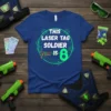 Blue t-shirt with text "THIS LASER TAG SOLDIER IS 8" and a laser gun graphic, designed for an 8th birthday