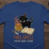 T-shirt design with the quote "This Spell Needs Some Blood" and a black witch cat brewing a potion, occult theme