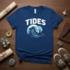 Tides T-Shirt with a large ocean wave and a lighthouse under a blue sky, featuring bold white text "TIDES"